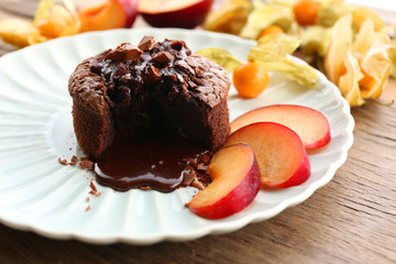 Hot chocolate pudding with fondant centre with fruits, close-up