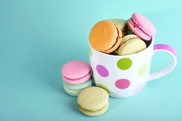 Assortment of gentle colorful macaroons in colorful mug