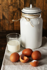 Milk can with eggs, eggshell and glass