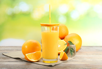 Glass of orange juice with straw and slices