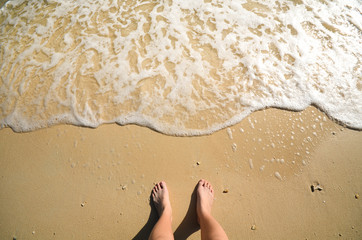 Foam and foot on sand