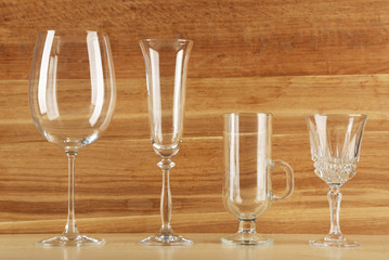 Empty goblets on wooden background