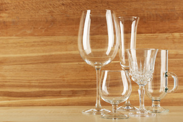 Empty goblets on wooden background