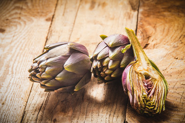 Fresh vegetables, artichoke on a wooden rustic background