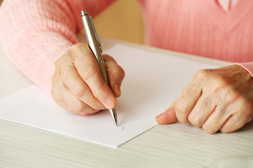 Hands of adult woman writing with pen,