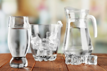 Glass of water with ice and bucket