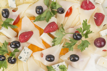 Plate with cheese decorated with strawberries