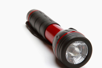 A flashlight lying isolated on white background