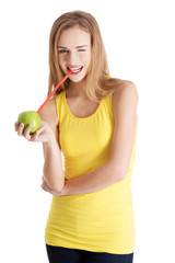 Attractive young woman is drinking apple.