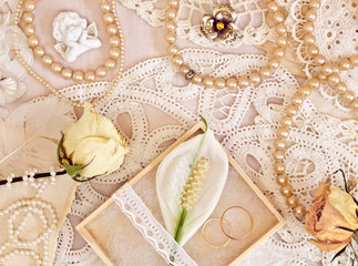 Wedding concept with flowers, rings and pearl beads