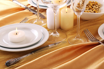 Beautiful holiday table setting in white and gold color