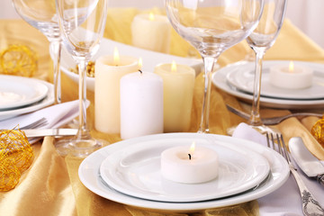 Beautiful holiday table setting in white and gold color