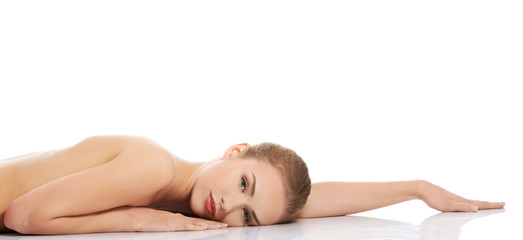 Obraz na płótnie Canvas Sexy fit naked woman lying on belly