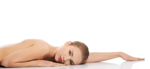 Zelfklevend Fotobehang Sexy fit naked woman lying on belly © Piotr Marcinski
