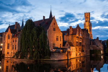 Buildings on canal at night in Bruges, Belgium
