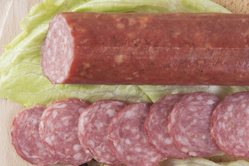 sliced salami on wooden board