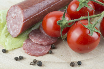 sliced salami with Cherry tomato and seasoned with black pepper