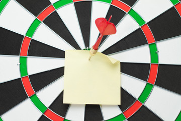 dart hit the centre of target and attaches sticker