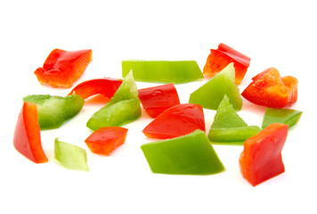 Chopped red and green pepper on white background.