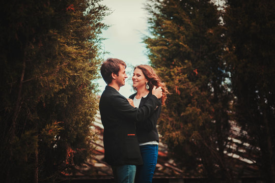 Happy outdoor portrait of young fashion couple posing