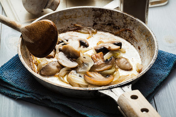 Sliced mushrooms with onion on a pan