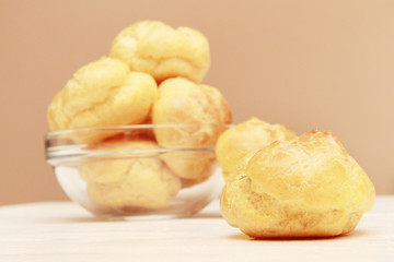 Tasty homemade pastry puffs in glass bowl