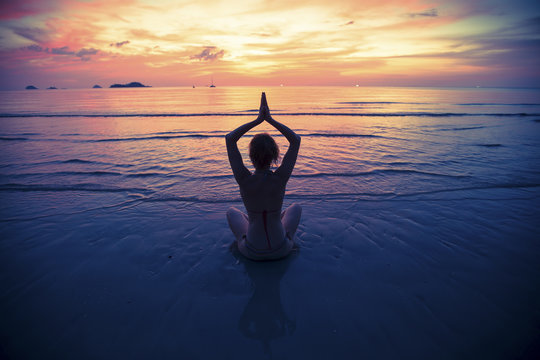 Yoga silhouette, exercises on the beach.
