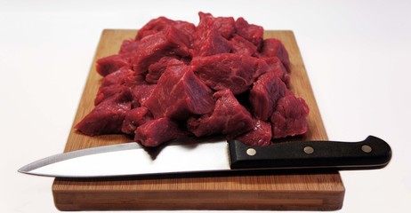 Raw meat, sliced on a cutting board