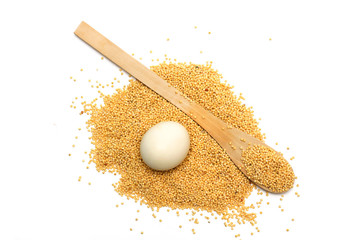 Wooden spoon with egg barley. Photo.