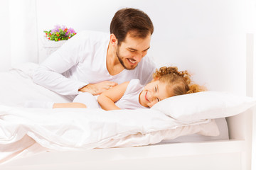 Happy father with cute small daughter playing