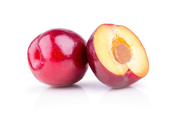 ripe juicy plums on a white background