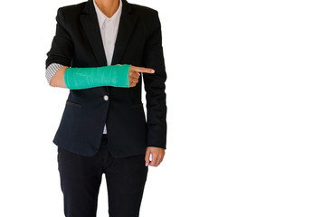 Injured businesswoman with green cast on hand and arm on white b