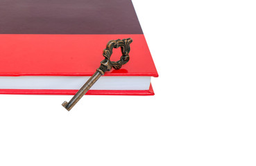 old key on red book isolated.