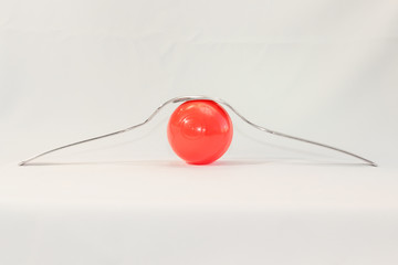 two forks and colored balls on a white background