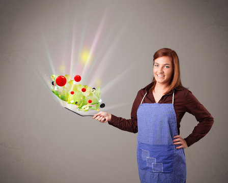 Young woman cooking fresh vegetables