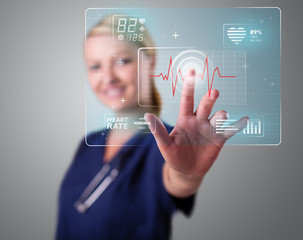 Young nurse pressing modern medical type of buttons