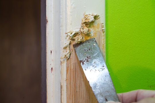 Scraping paint off of a door frame