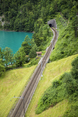 Rails leading to a tunnel in a mountain in Switzerland