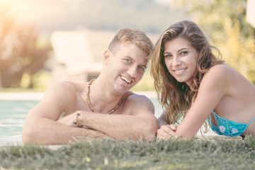 Fototapeta premium Beautiful Young Couple Next to Swimming Pool