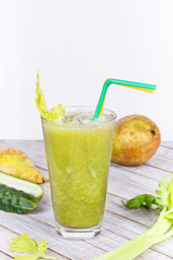 Fototapeta premium Cucumber, pear and celery juice. Slices of fruits and vegetables