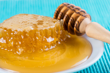 Honey comp with fresh honey and wooden dipper