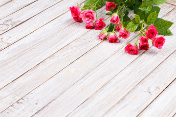Red roses on wooden backround. Copy space