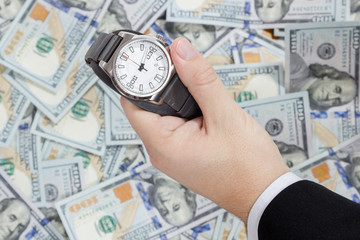 Wristwatch on dollars background