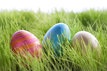 Three Colorful Easter Eggs On Green Gras