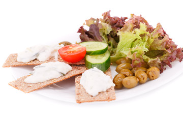 Cracker with fresh vegetables and cream