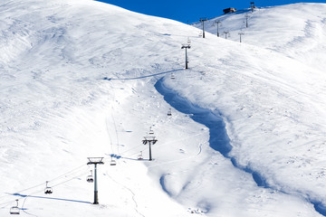 Aerial View of ski lifts over the snowed mountain