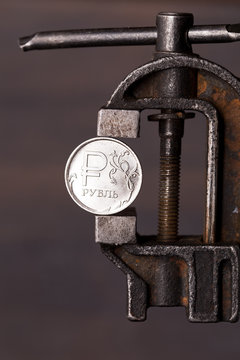 Russian ruble coin in old vise