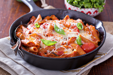Pasta bake with penne, tomatoes and mozarella