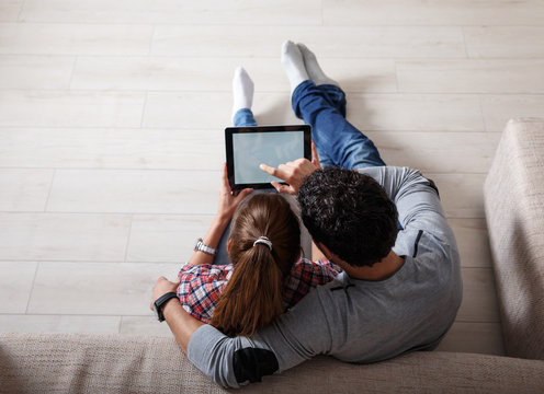 Young couple using tablet.Relaxing.