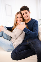 lovely cheerful young couple man woman happy together at home